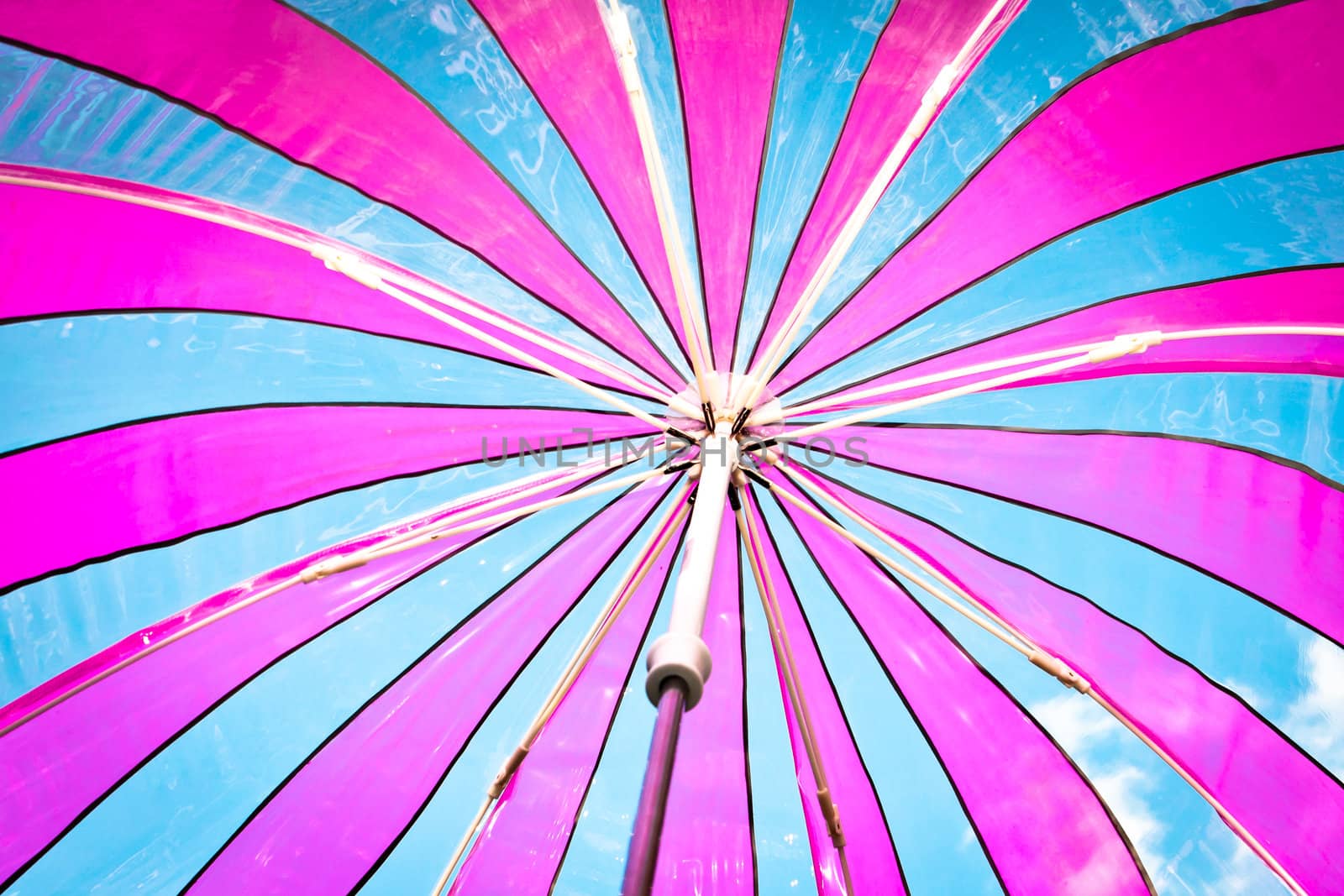 View from inside a colorful plastic umbrella