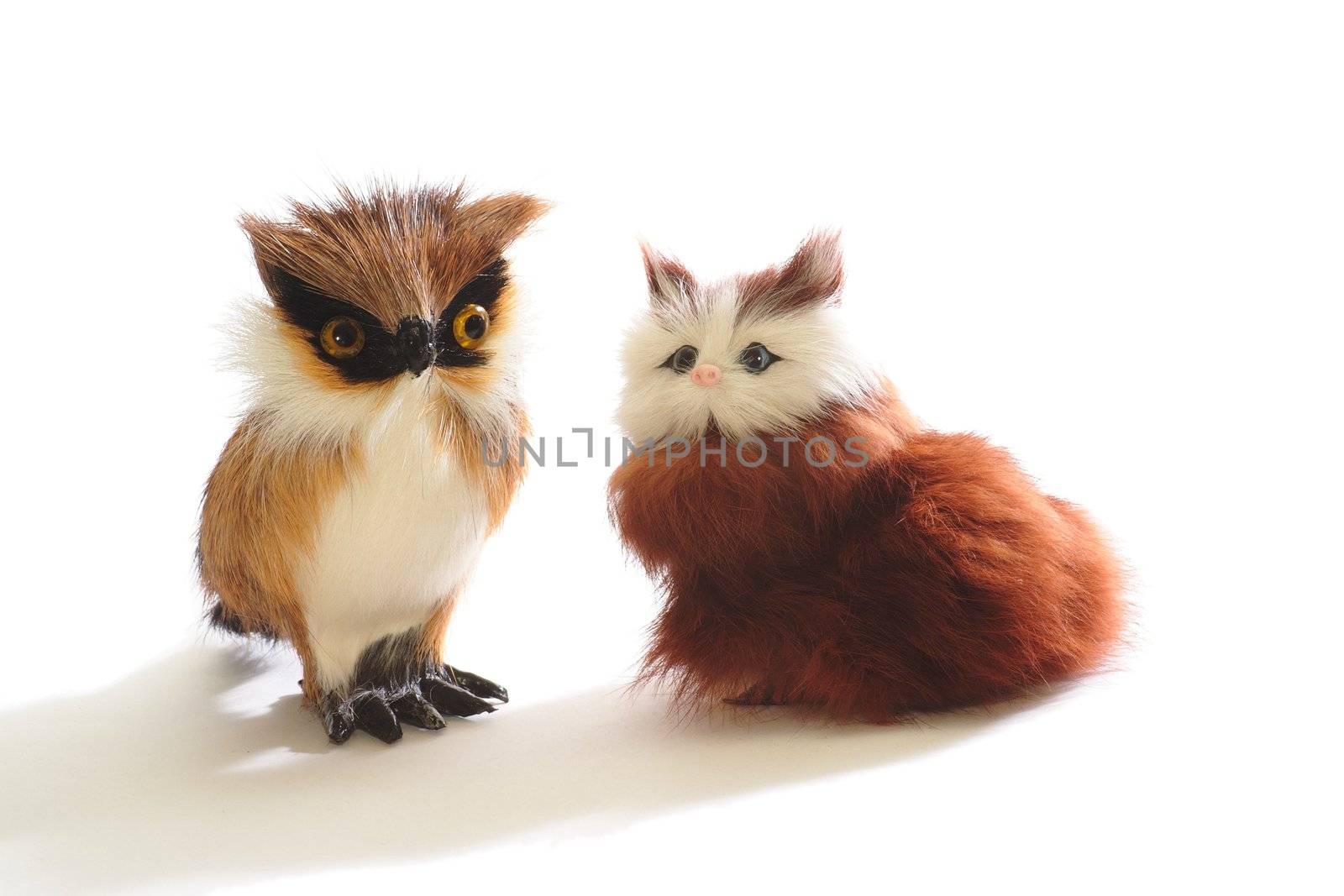 Pair of cute fluffy toys: kitten and owl, isolated on white background