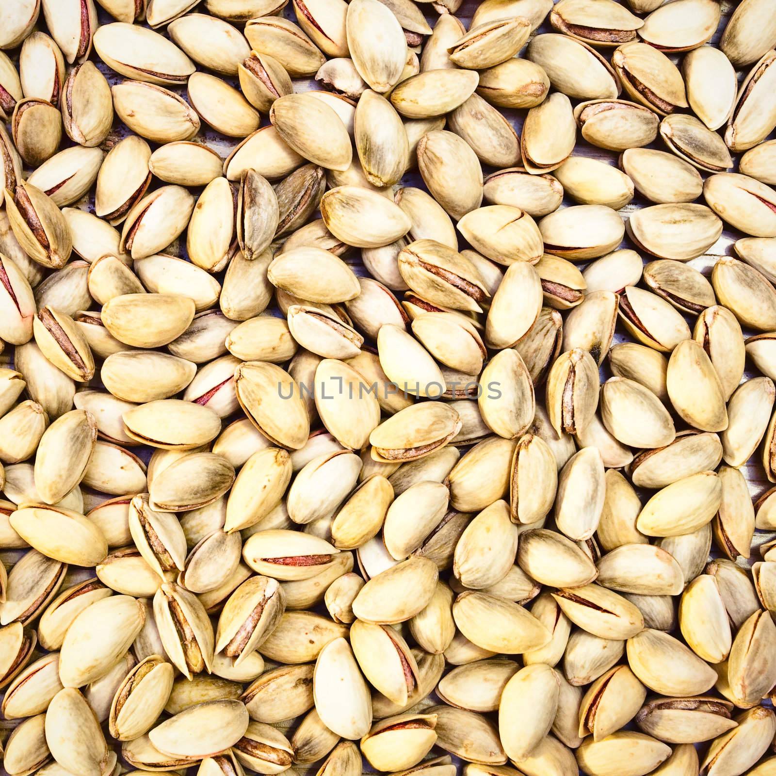 Beautiful detailed square picture of pistachio nuts as a background