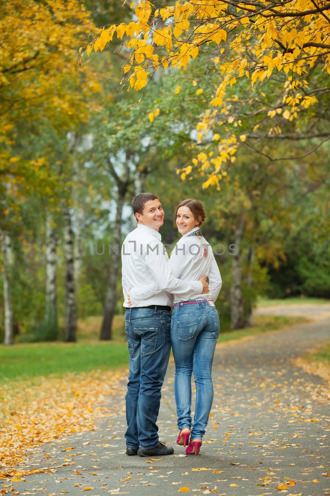 Romantic happy young beautiful couple on autumn walk. Vertical view