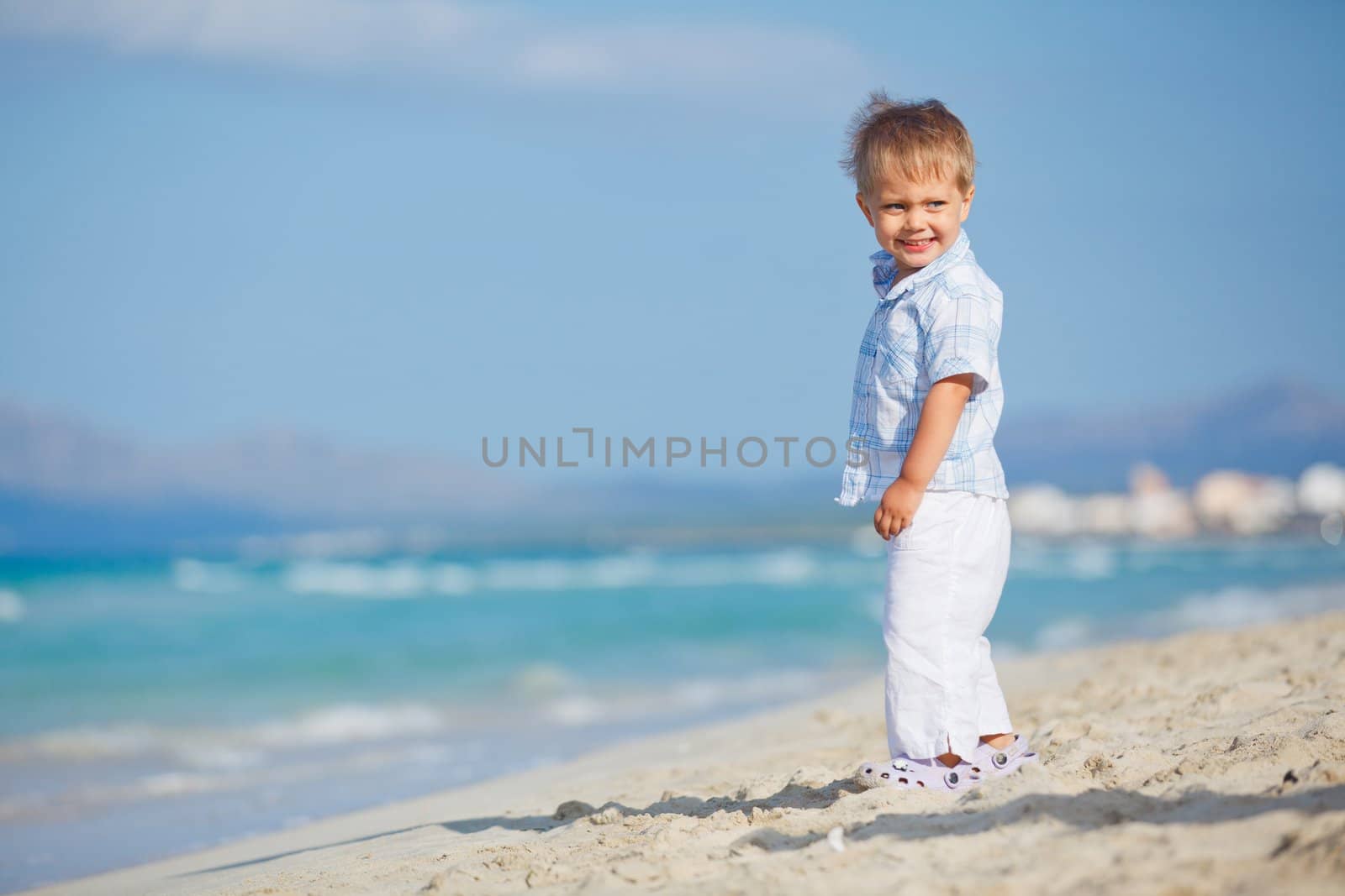Little cute boy on the beautiful exotic white beach, Mallorca, Spain