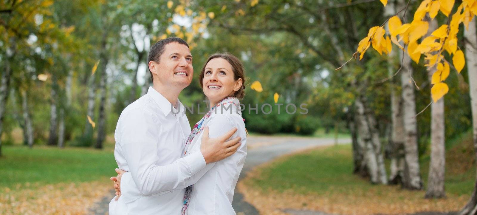 Romantic young beautiful couple on autumn walk by maxoliki