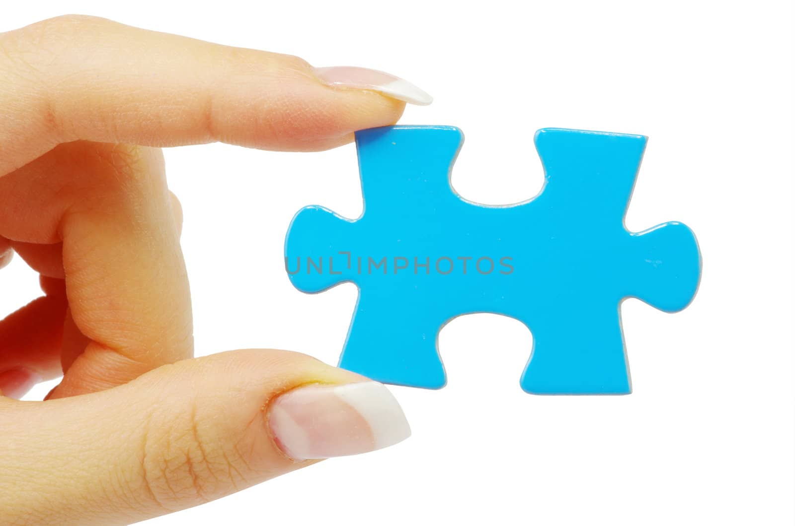 hand holding a puzzle piece
