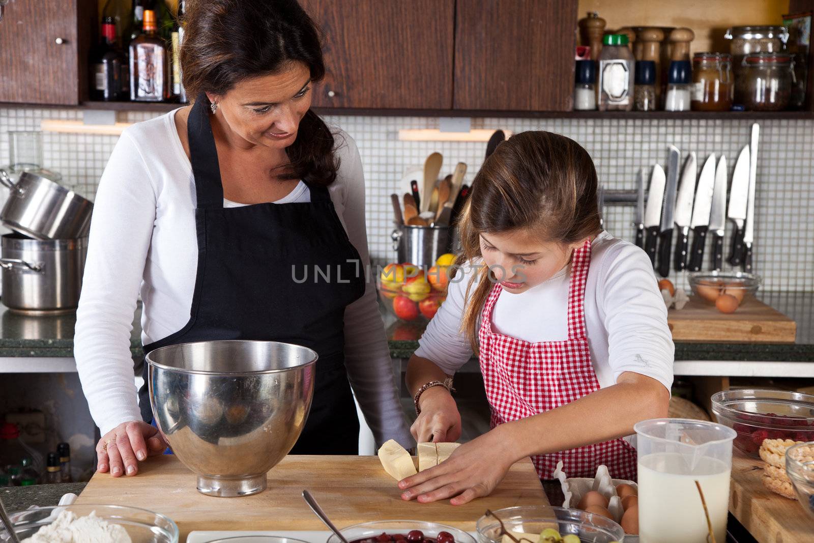 Mother and child in the kitchen baking together