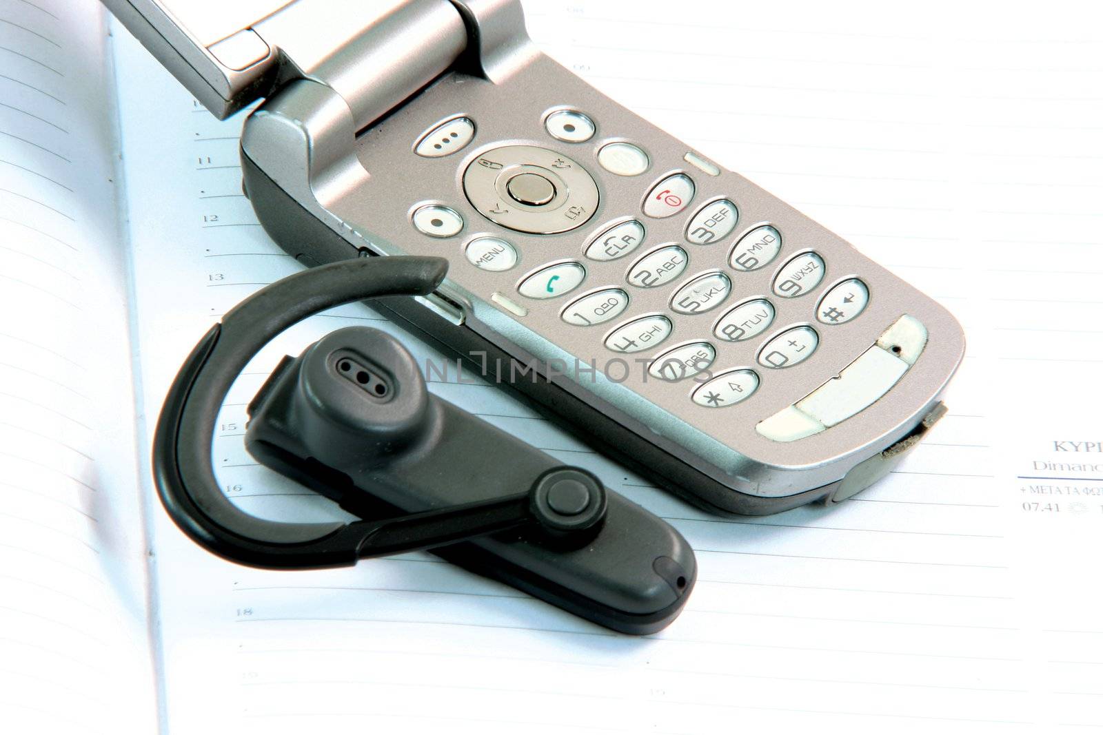 cell phone detail with hands free on diary communication concepts