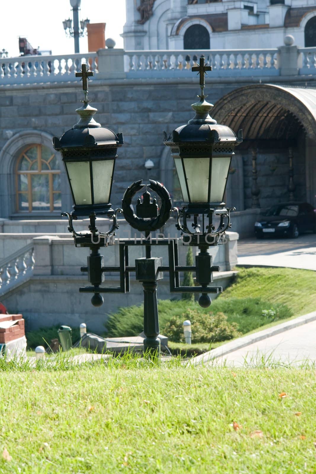 Street lantern with Christian symbolics near a monastery
