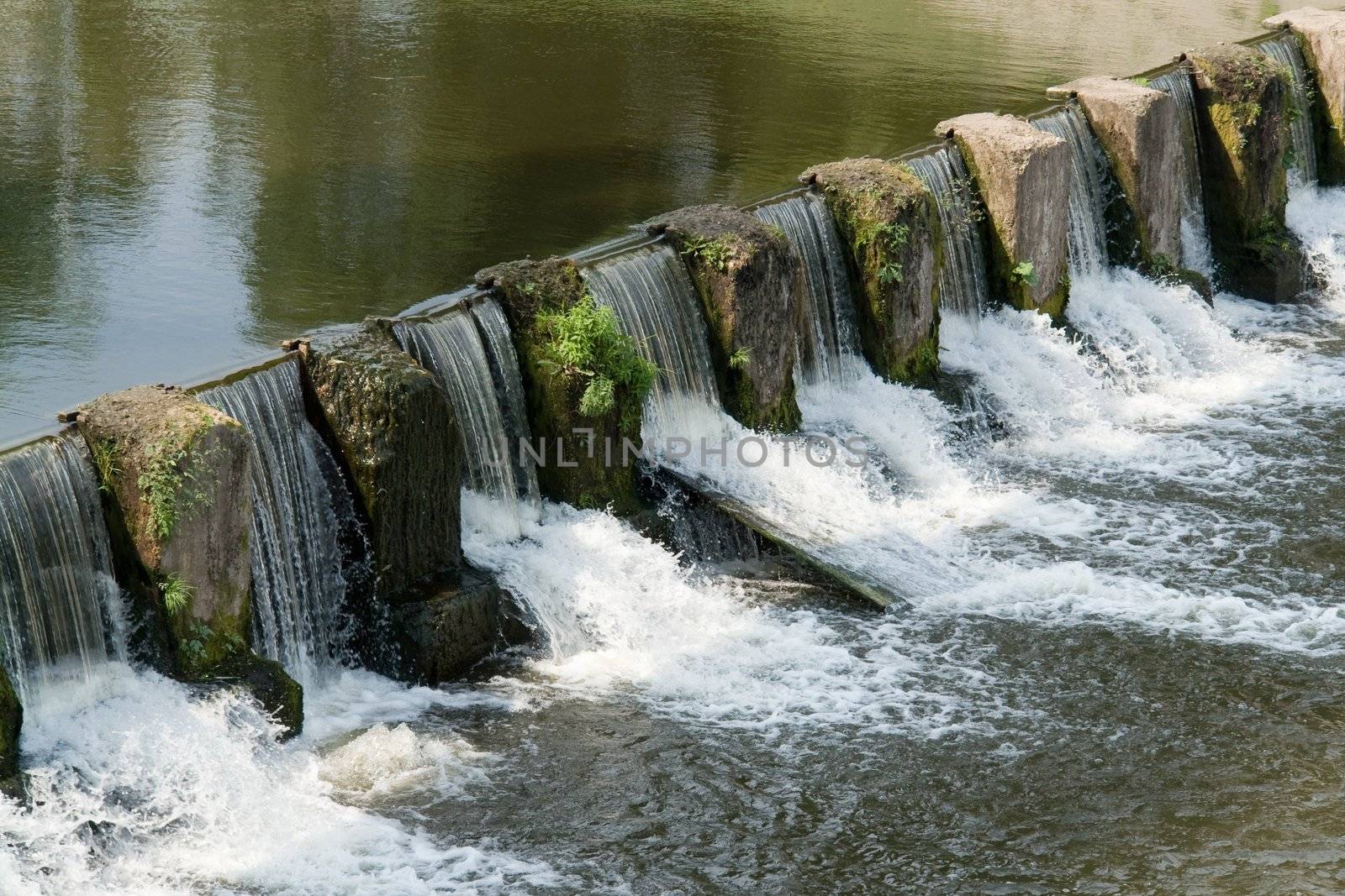the cascade. Overflow dam on small river