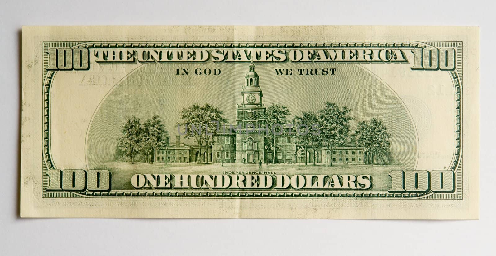 hundred dollar bill on a grey background