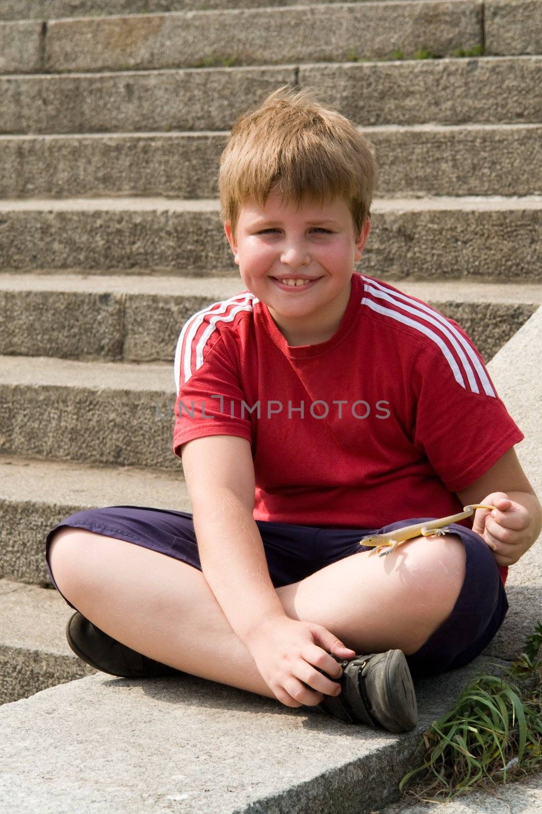 The little boy with the toy lizard in hands