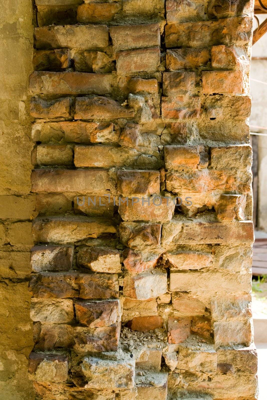 the brickwork. An ancient, weathered brick wall