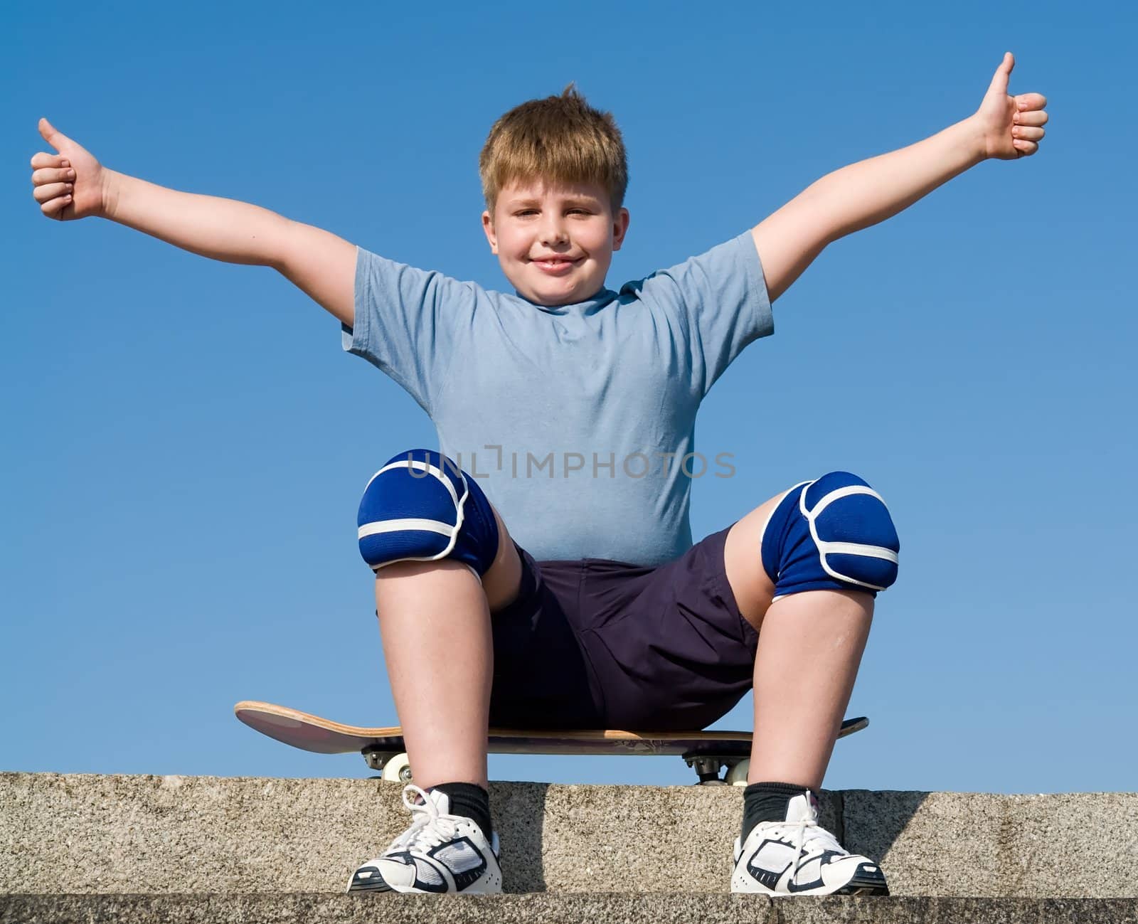 boy with skateboard on a blue sky
