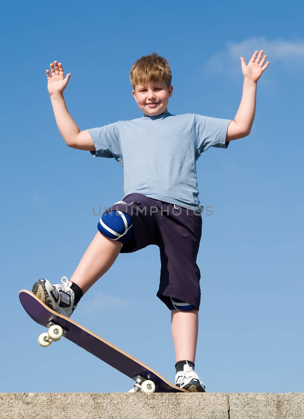 boy with skateboard on a blue sky