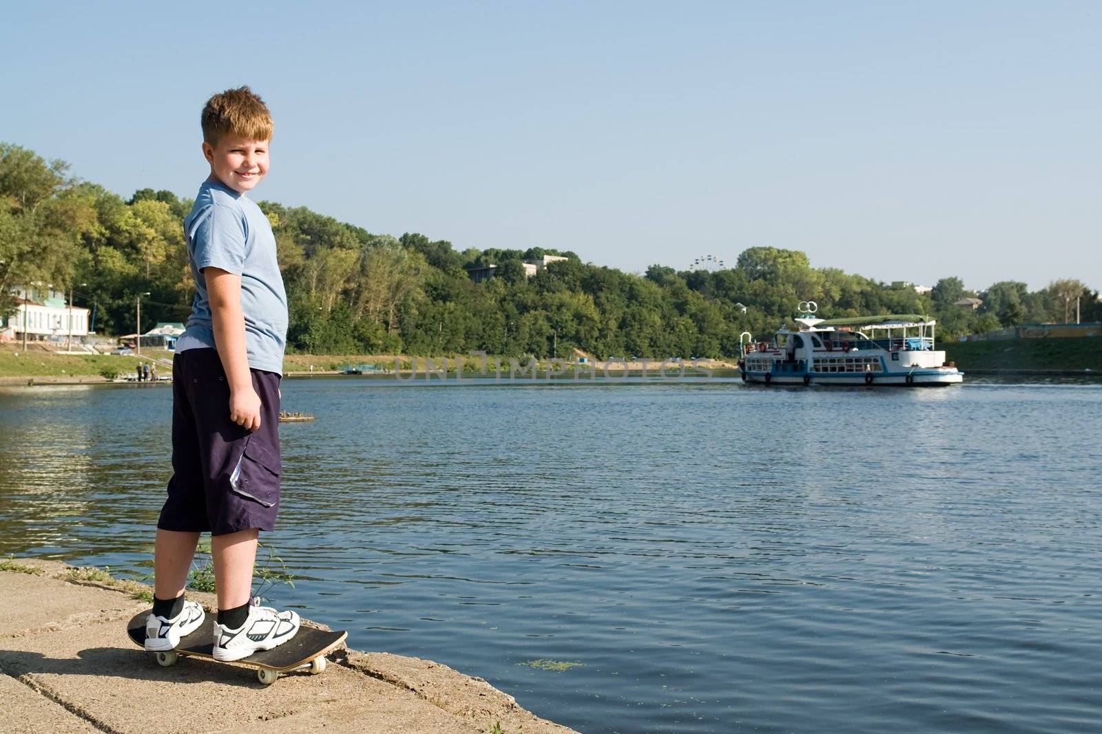boy on a skateboard with river at background
