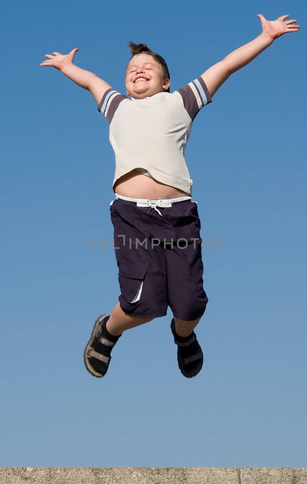 jumping boy with blue sky at background