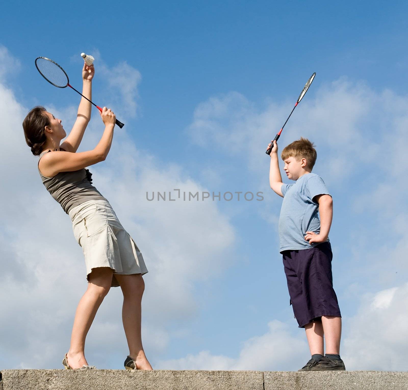 Family playing badminton on a blue sky
