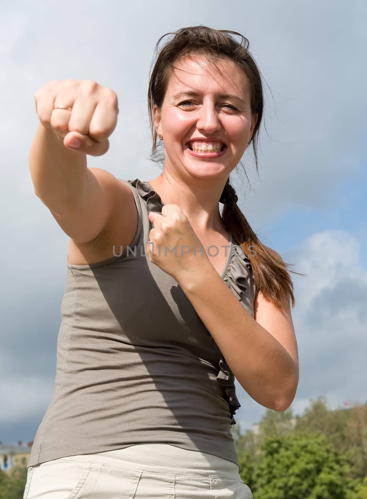 karate. fighter woman with blue sky at background