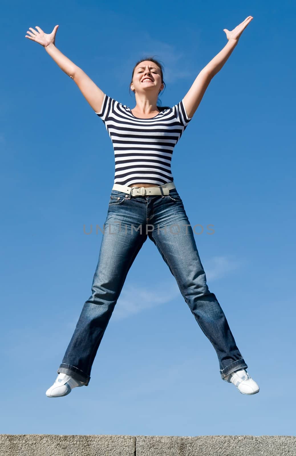 jumping girl with blue sky at background