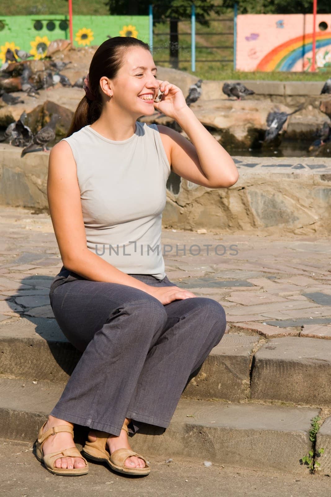 girl with mobile phone In a summer park