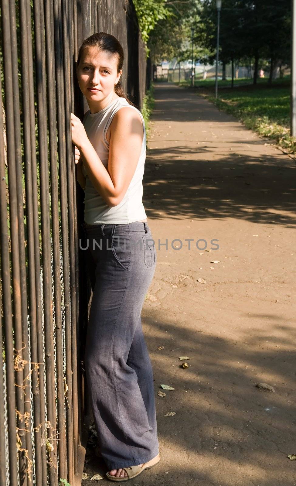 portrait of a beautiful woman near a fence