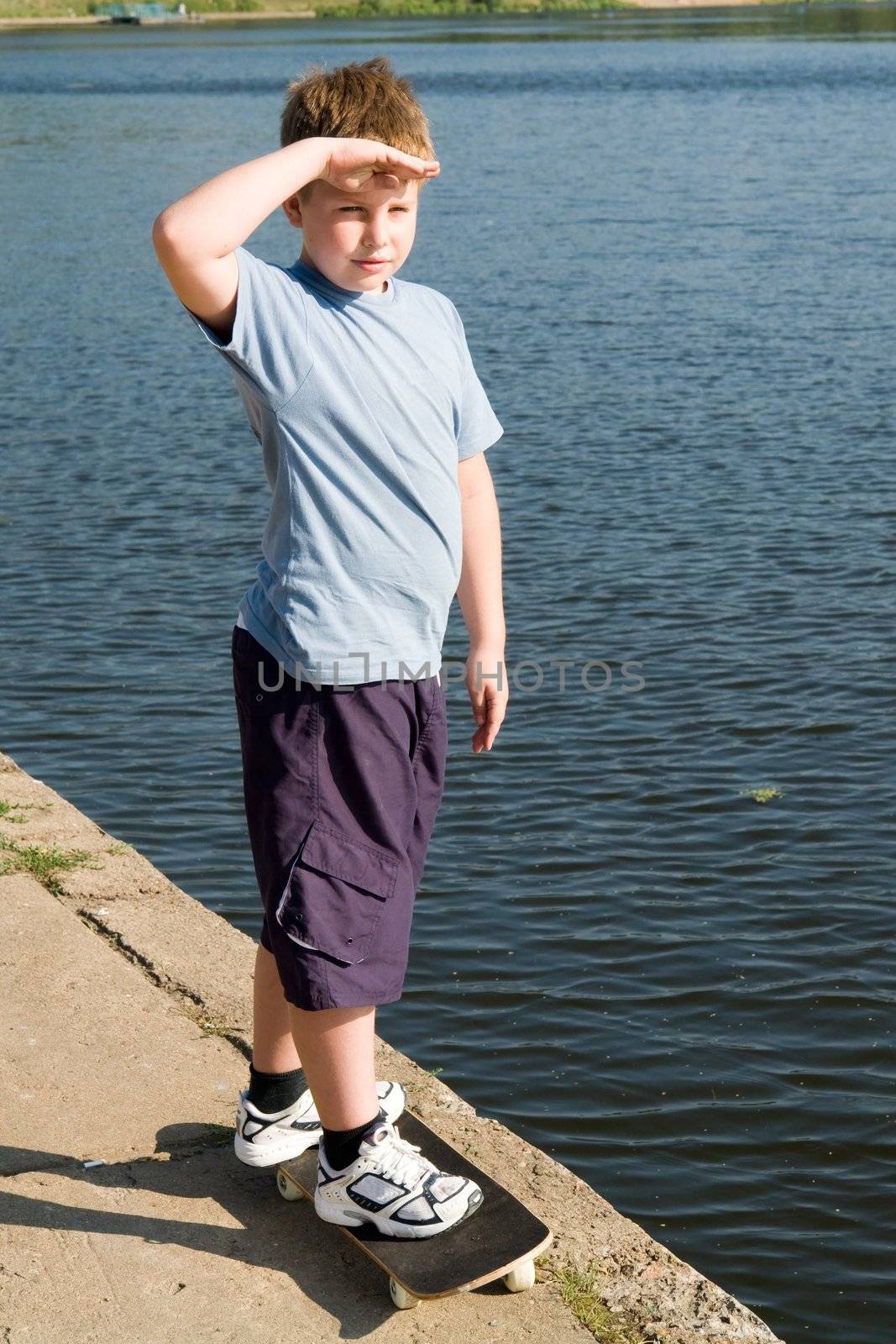 boy on a skateboard with river at background