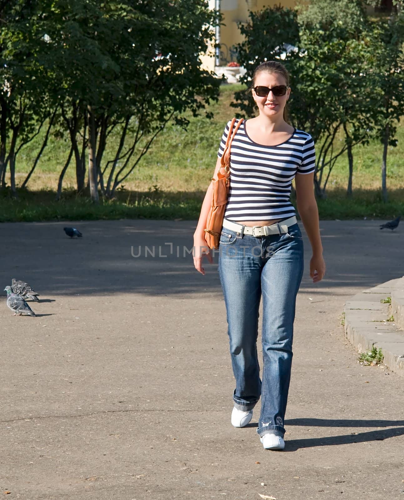 Walk. The young woman walks in park.