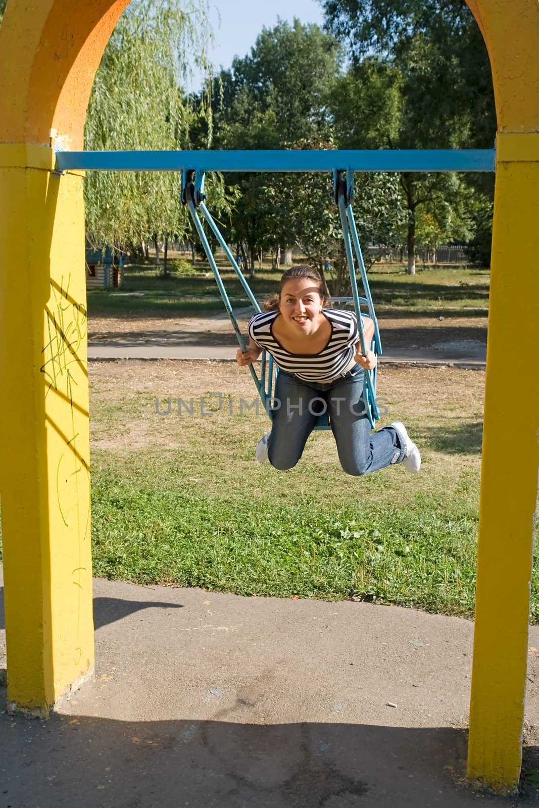 girl on a swing in city park