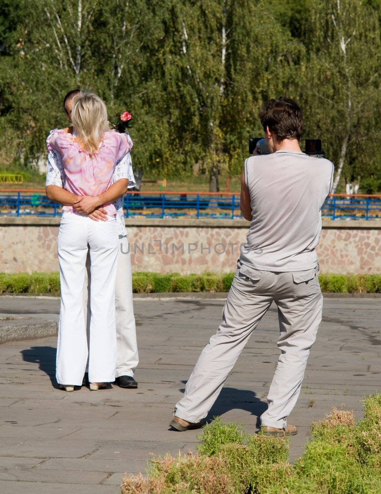 Young kissing couple. Before wedding video shooting.