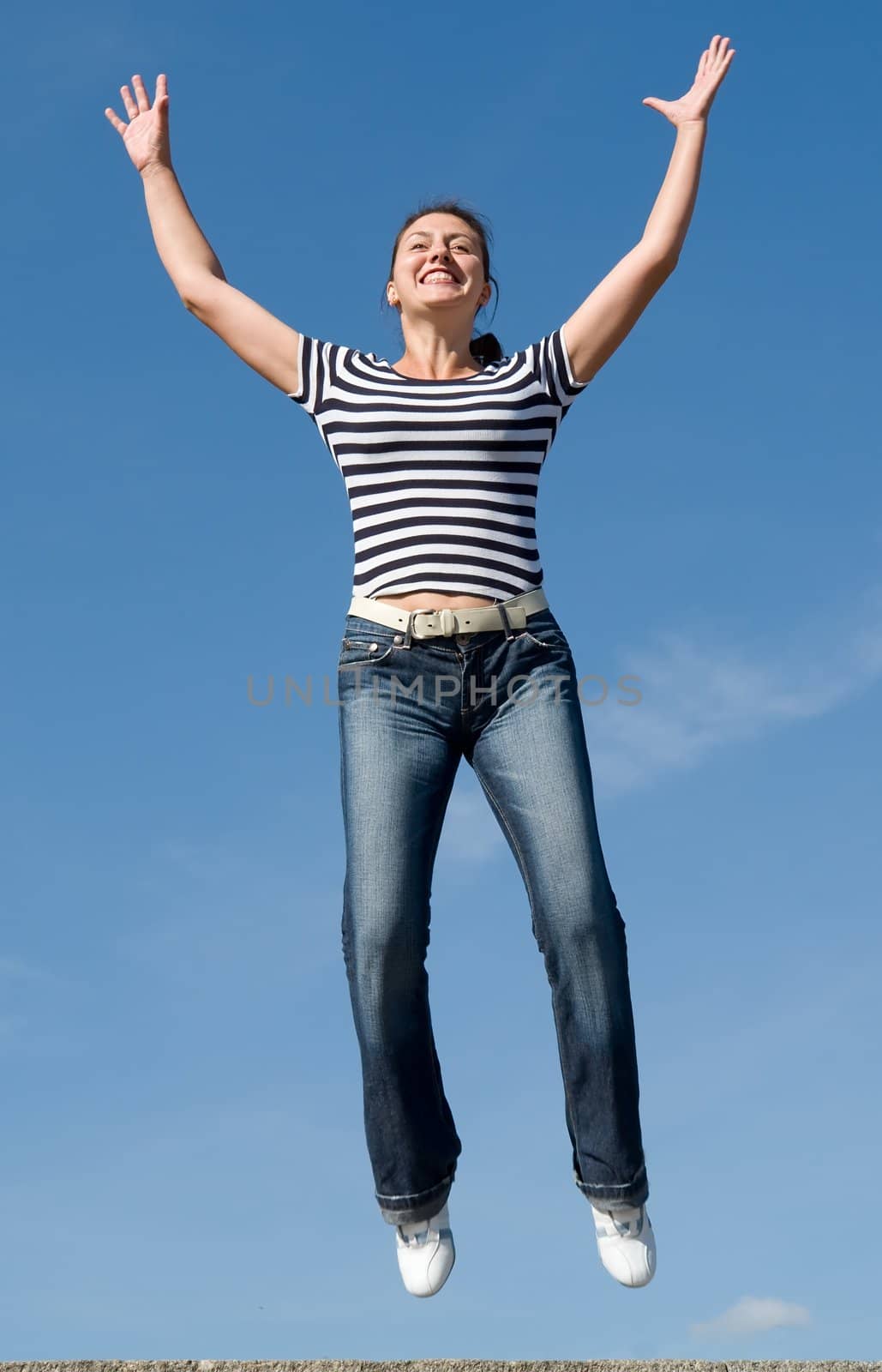 jumping woman with blue sky at background