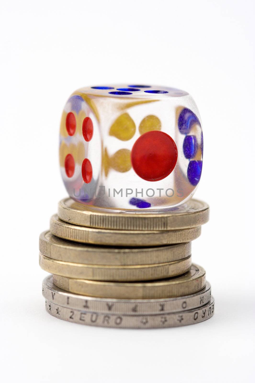 Dice on stack of coins,close up,over white