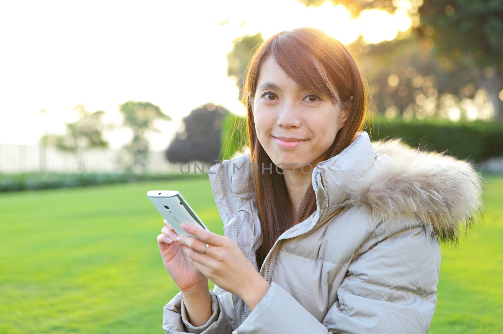 young woman with phone outdoors