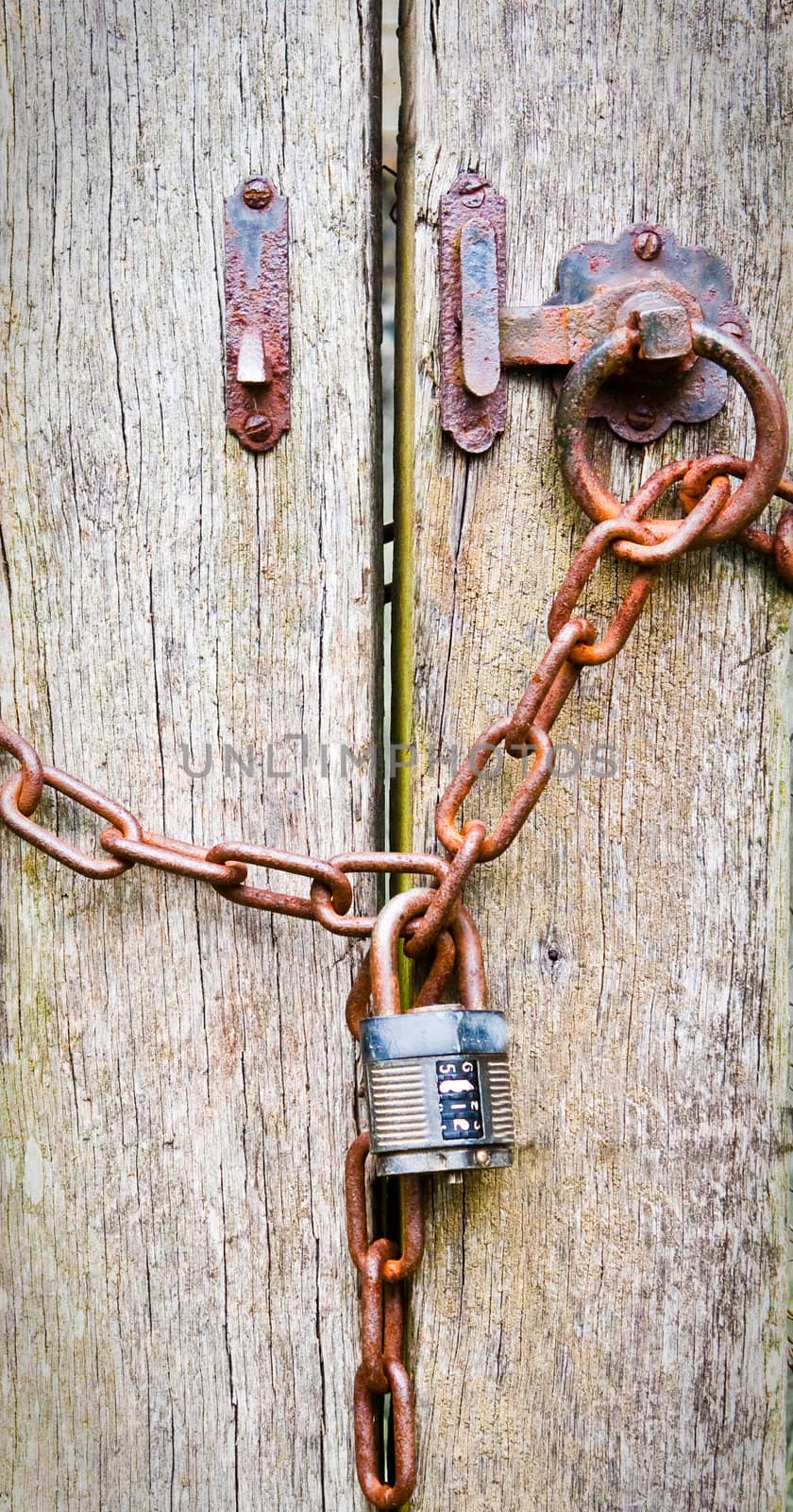 Close up background image of a wooden gate chained and locked