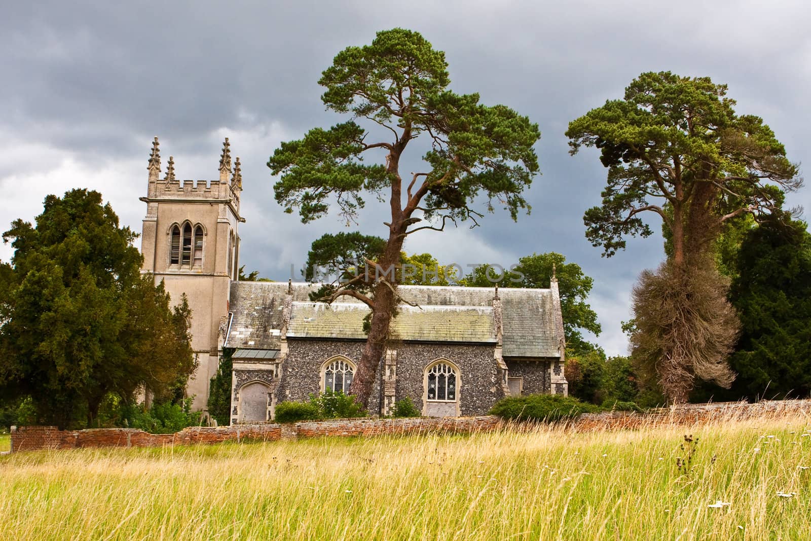 An old englis church on a hillside on a stormy summer day
