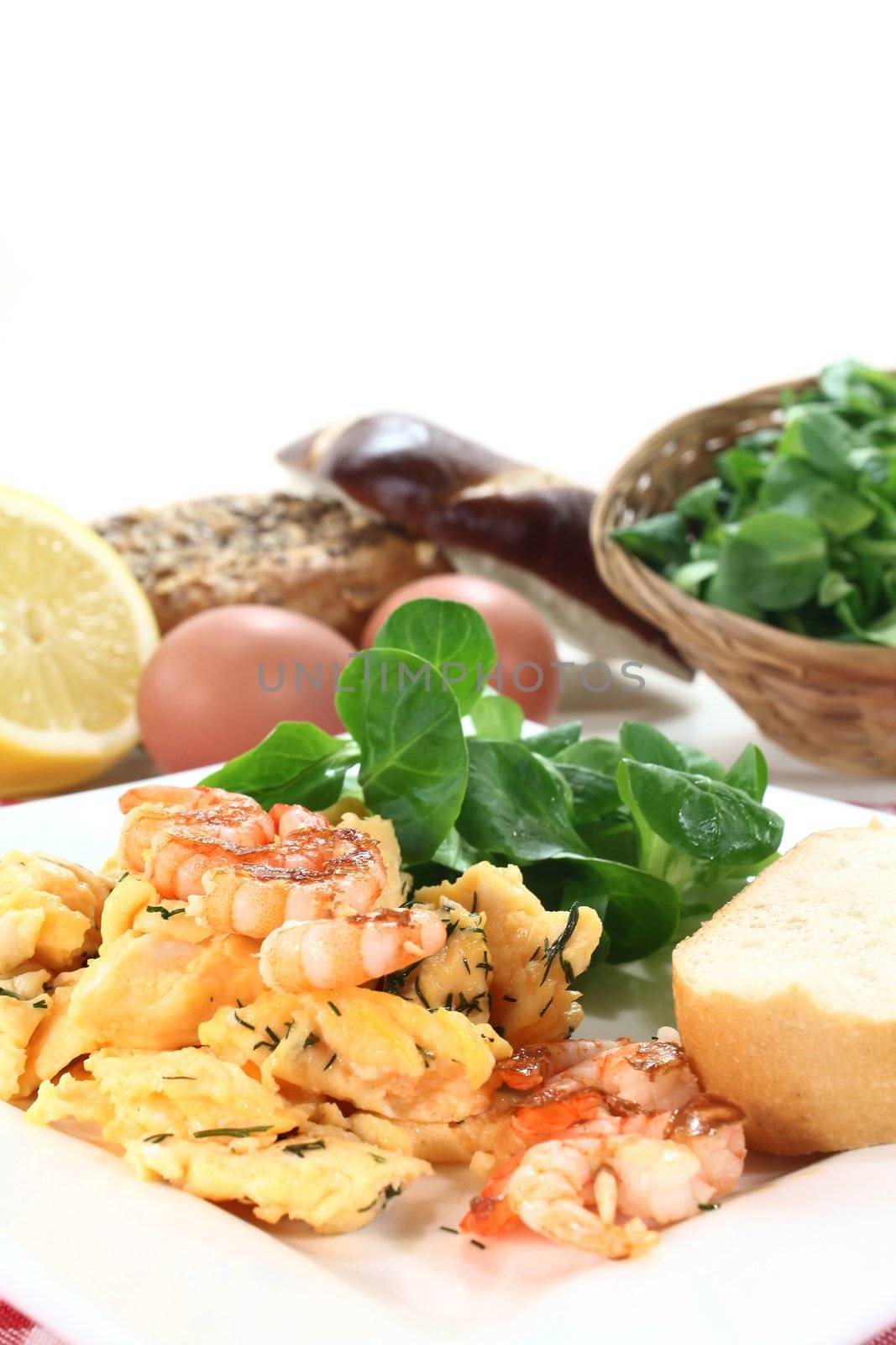 Scrambled eggs with shrimp, dill and corn salad on a plate