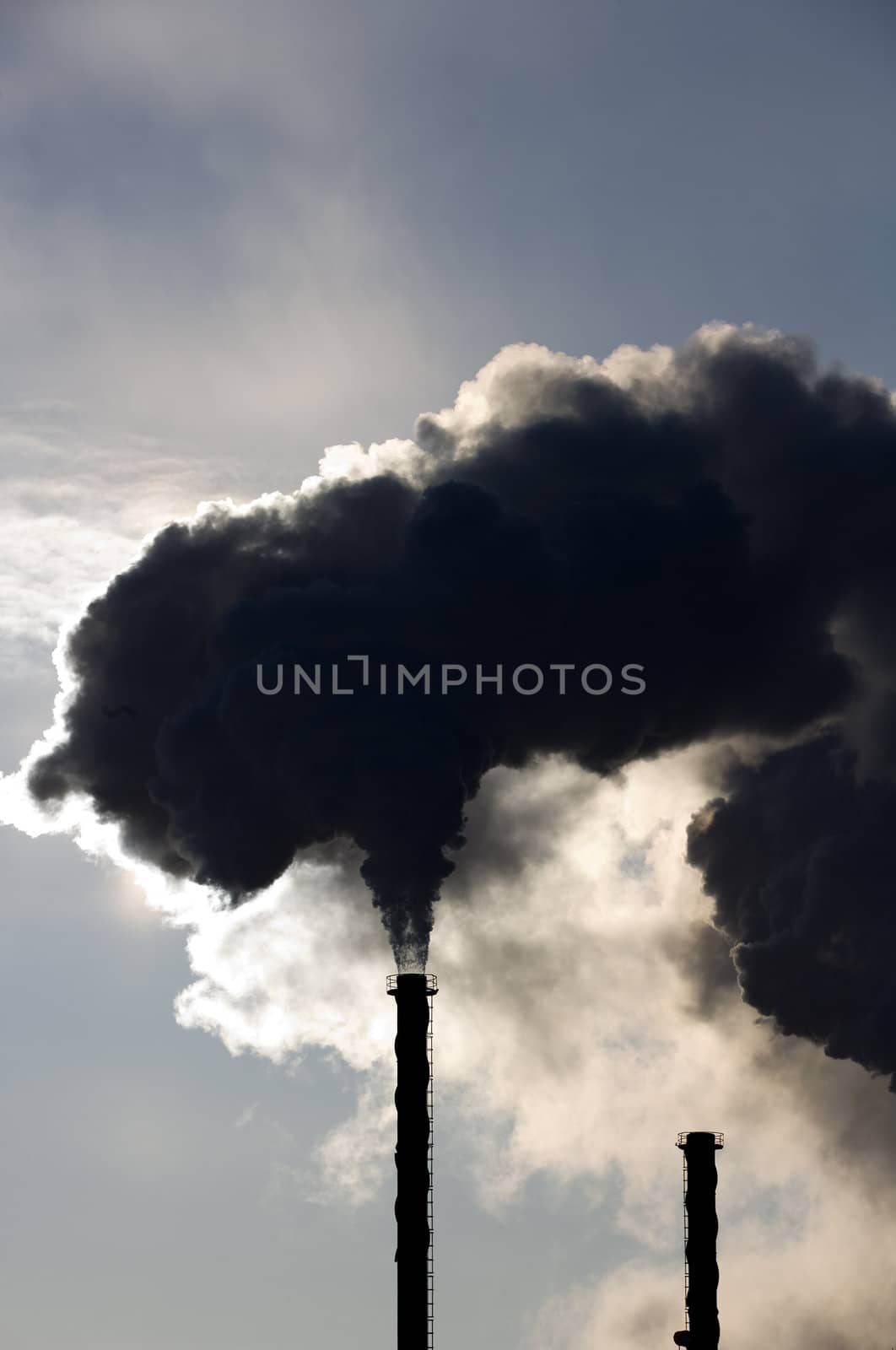 Black smoke from an industrial pipe