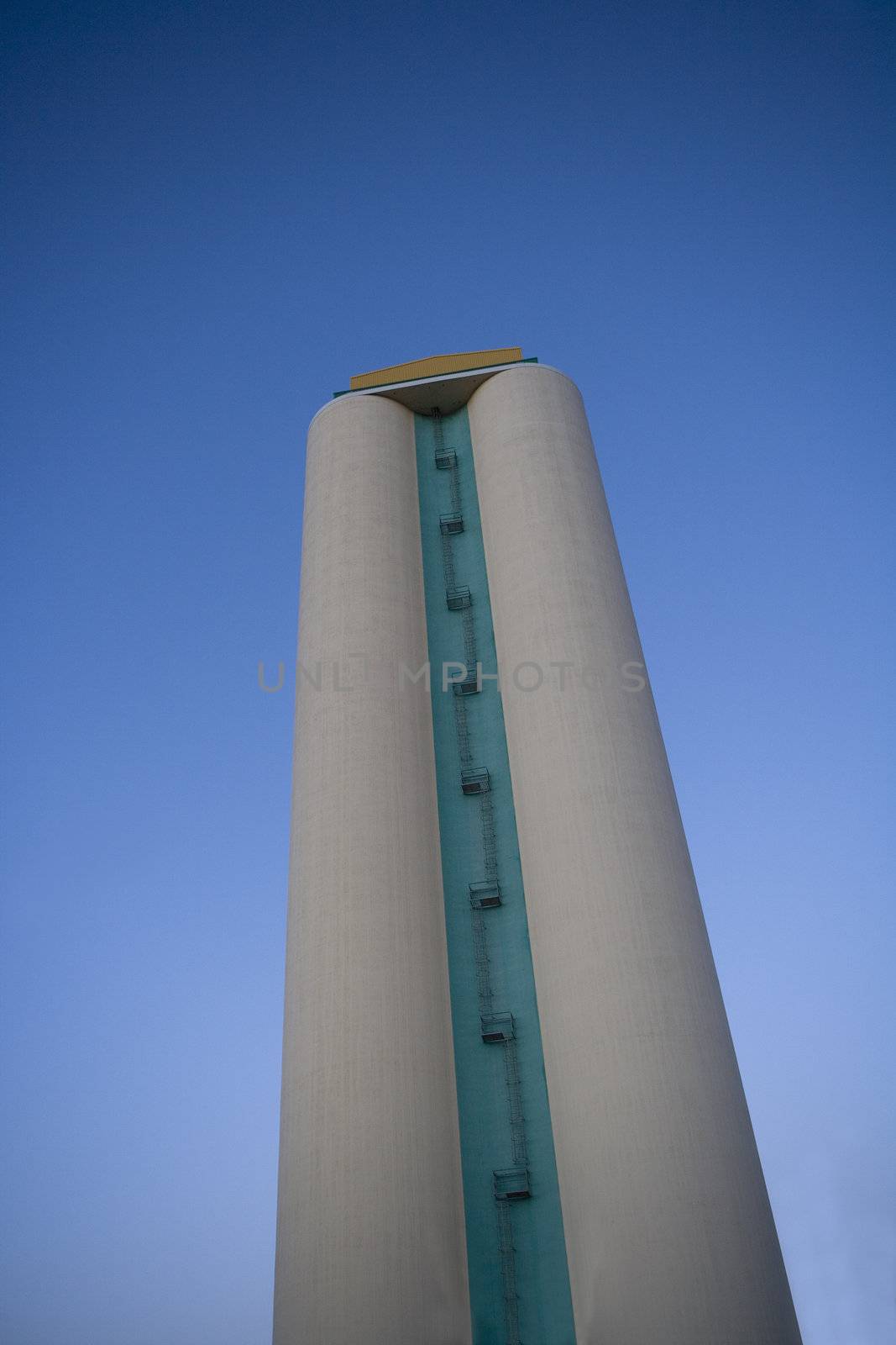 Silo towards blue sky from low angle view