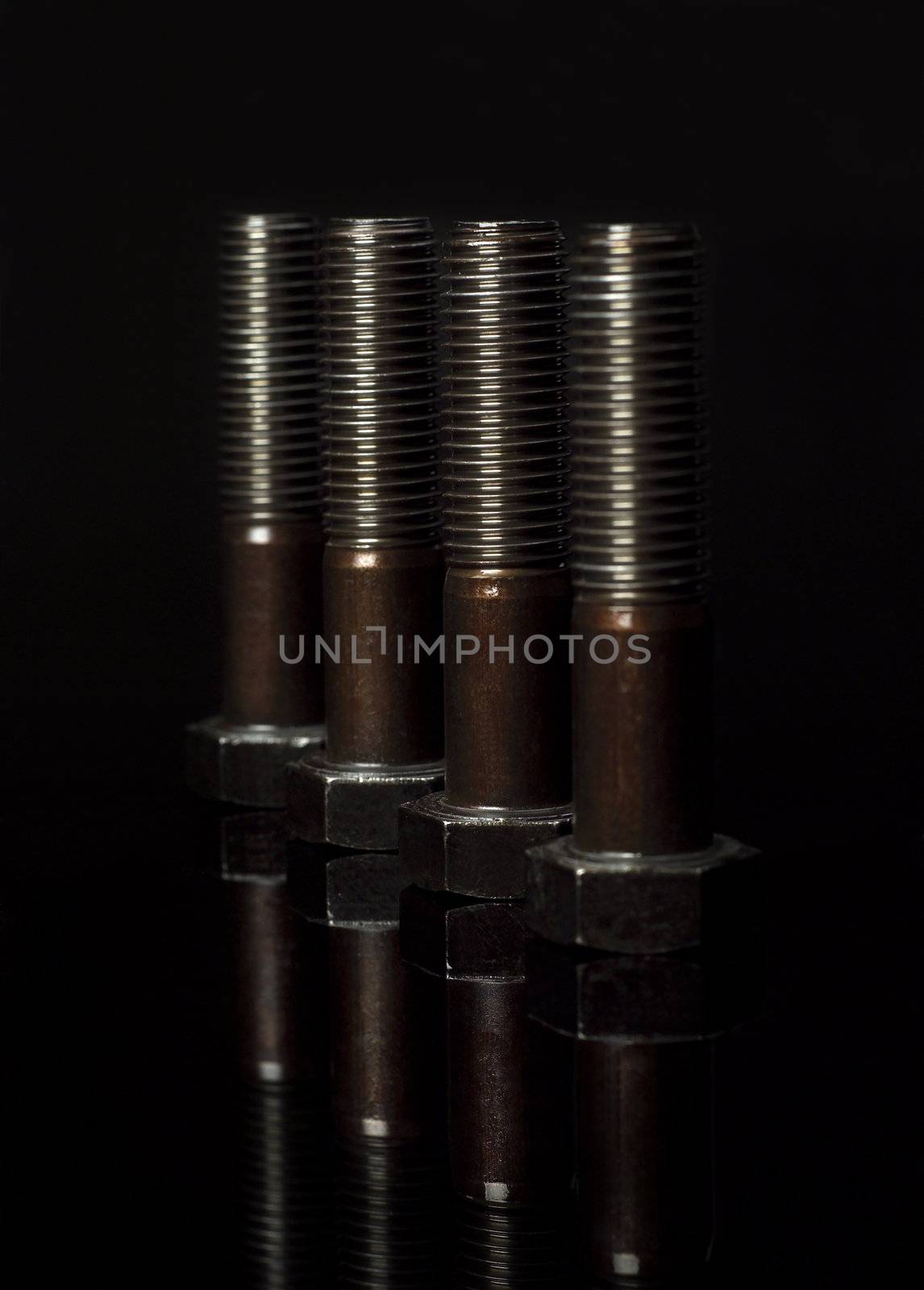 Group of screws on black background