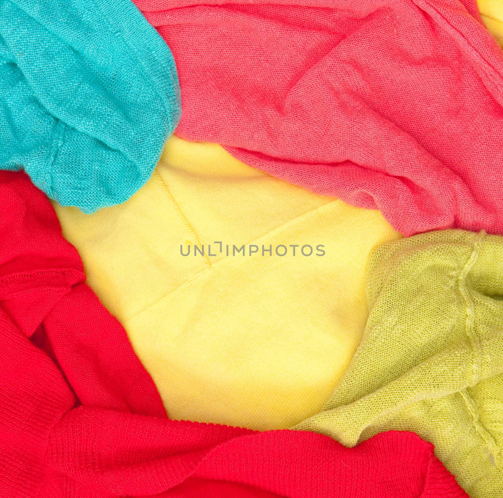 A background composed of colorful womens clothes in a pile for washing