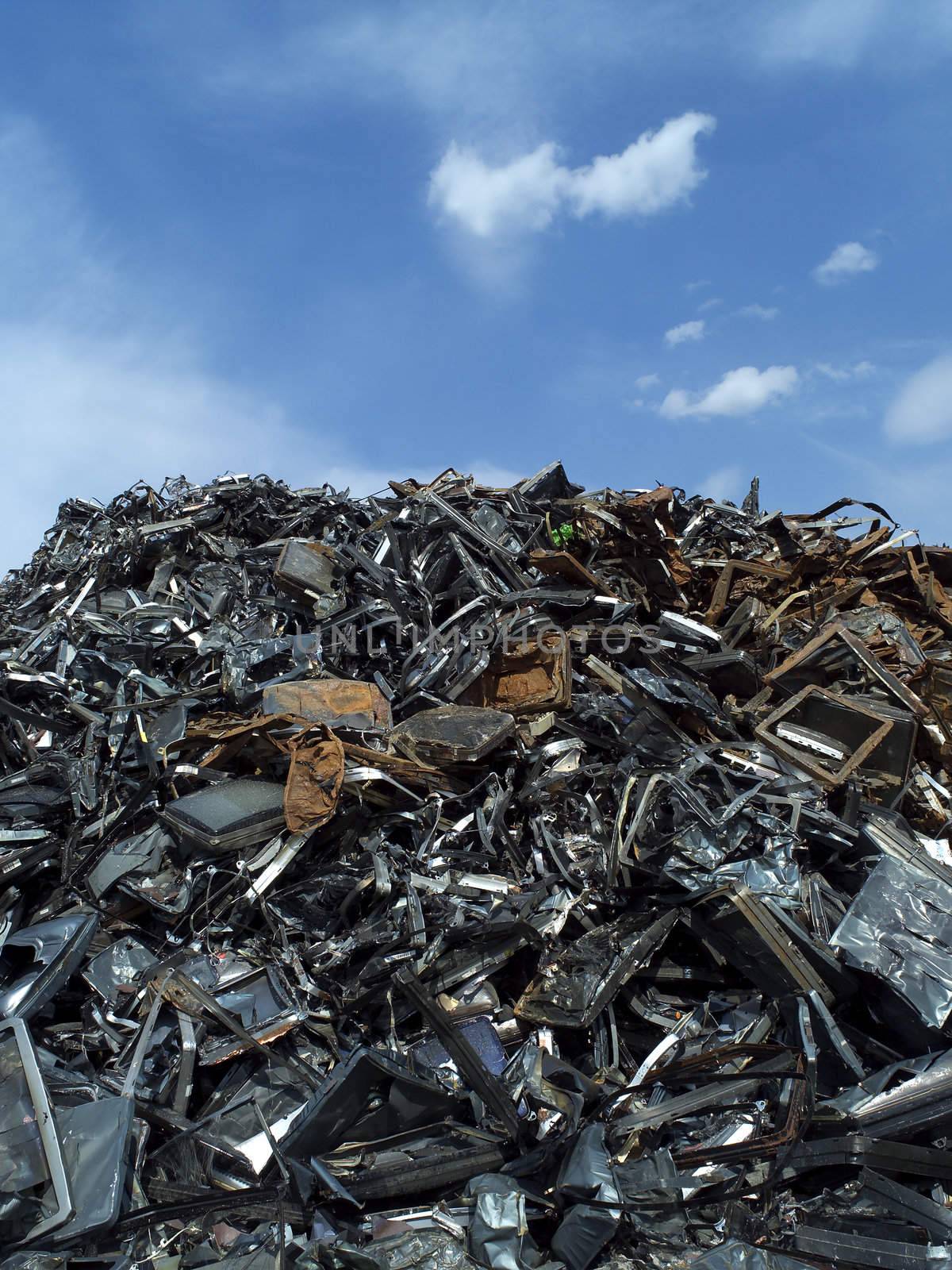 Stack of Metal Garbage in front of blue sky