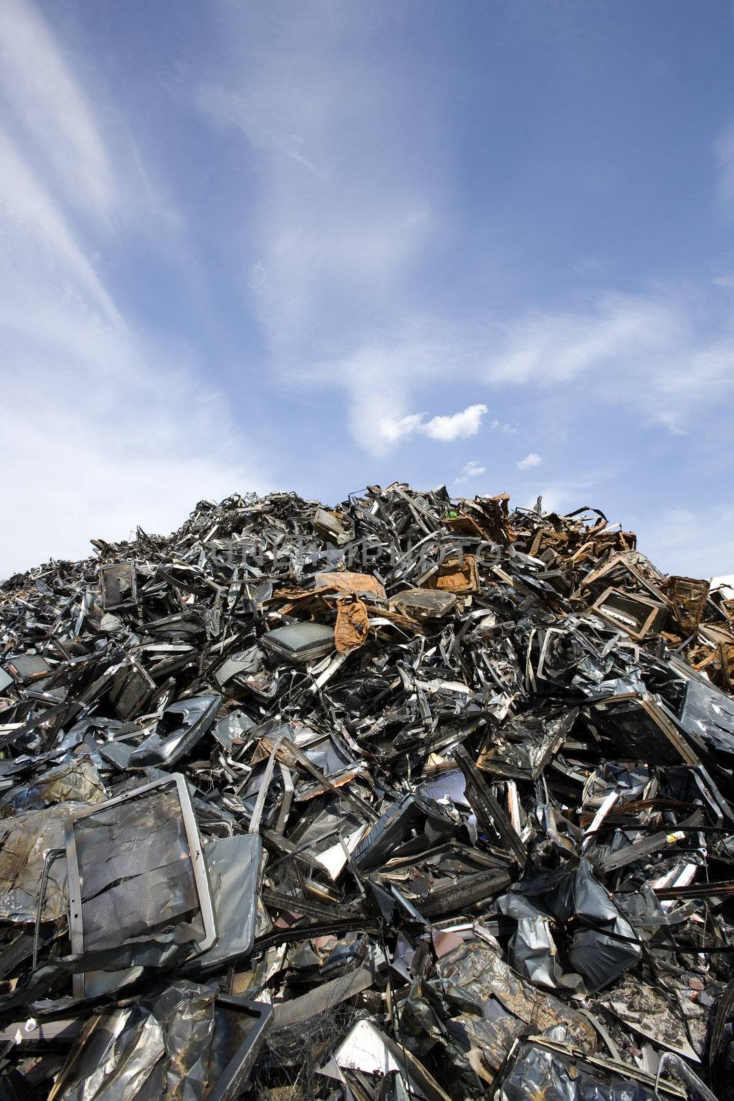 Stack of Metal Garbage in front of blue sky