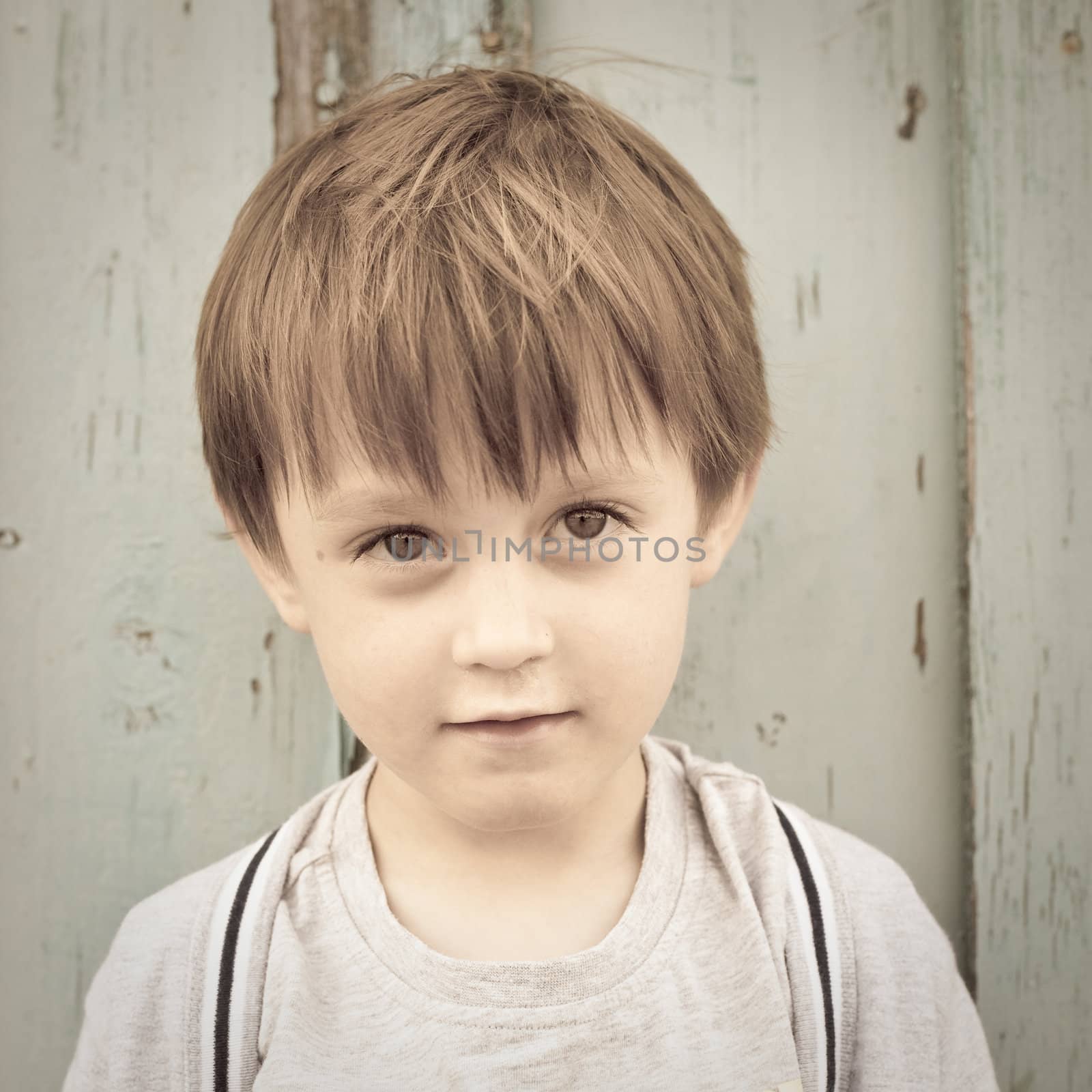 Adorable three year old boy in sepia tones