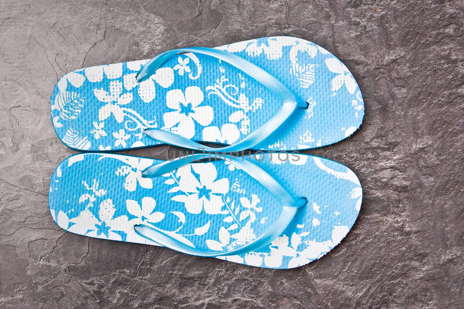 Nice blue flip flops on a slate surface