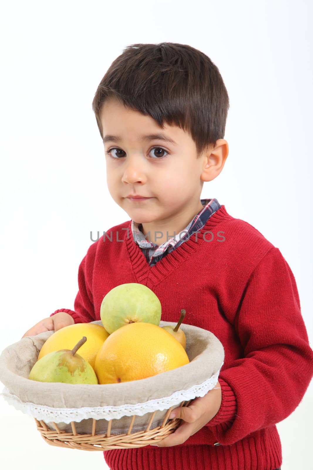 Child bringind basket fruit on white background