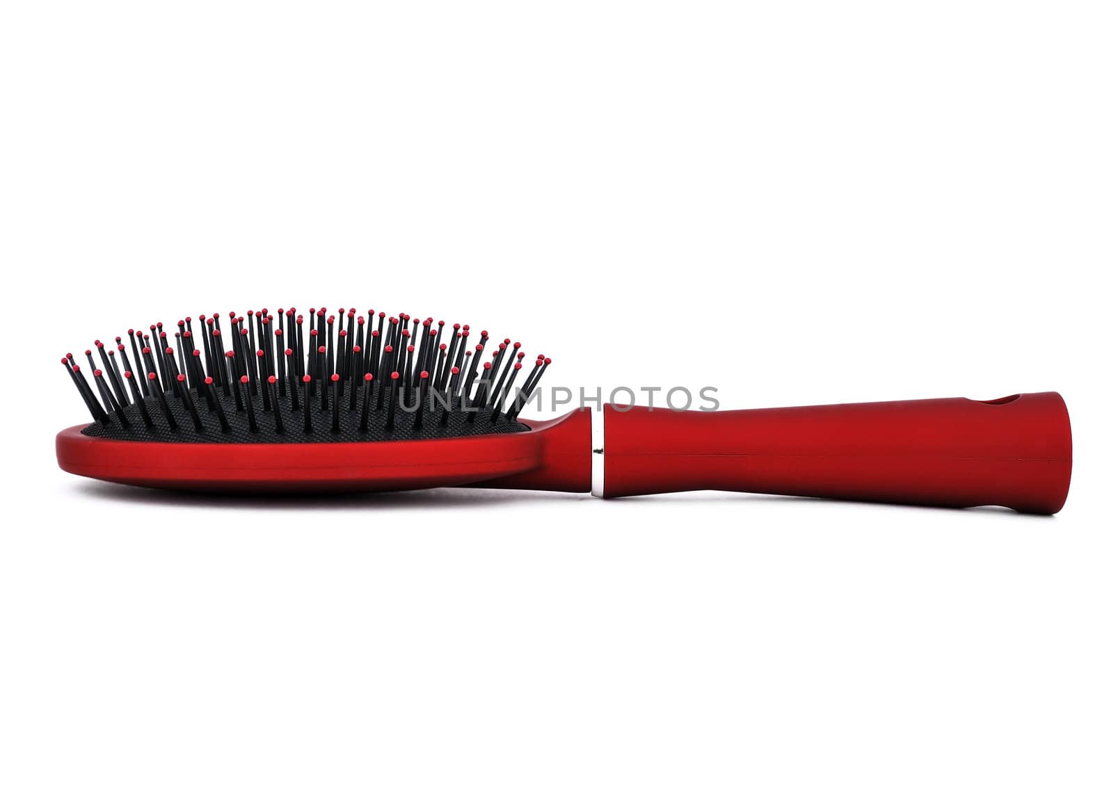 red comb the hair on a white background