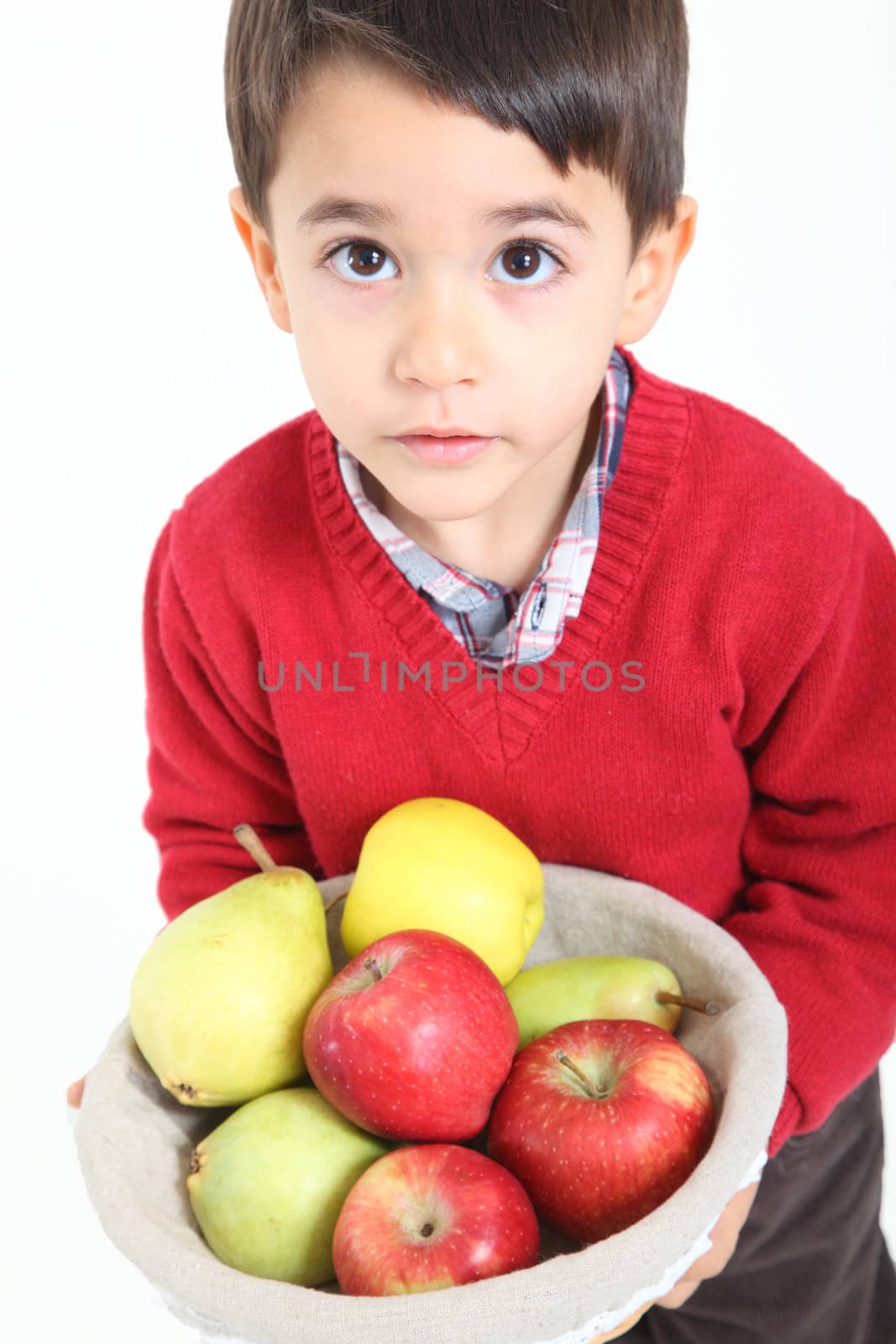 Child bringind basket fruit on white background
