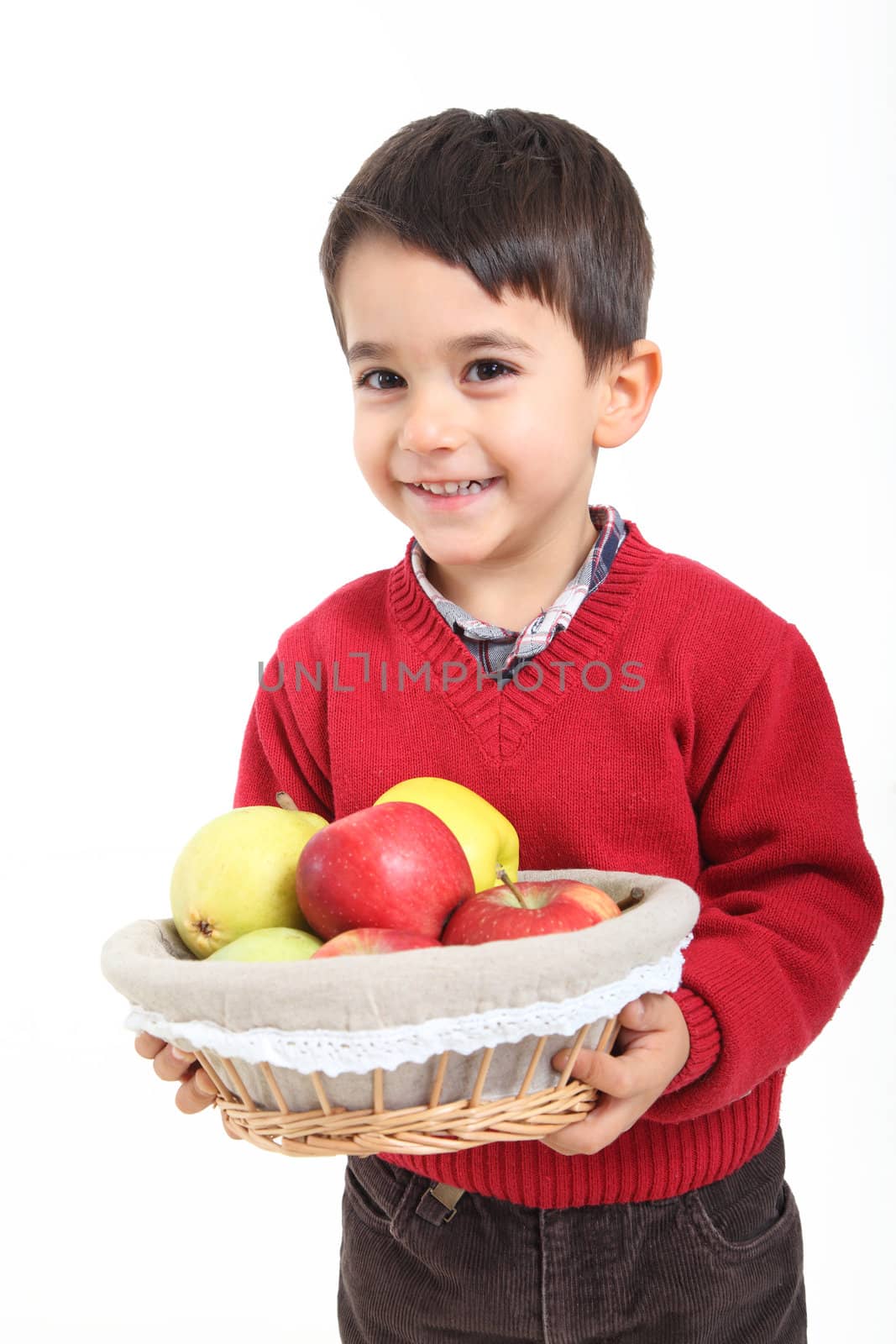 Child bringind basket fruit on white background