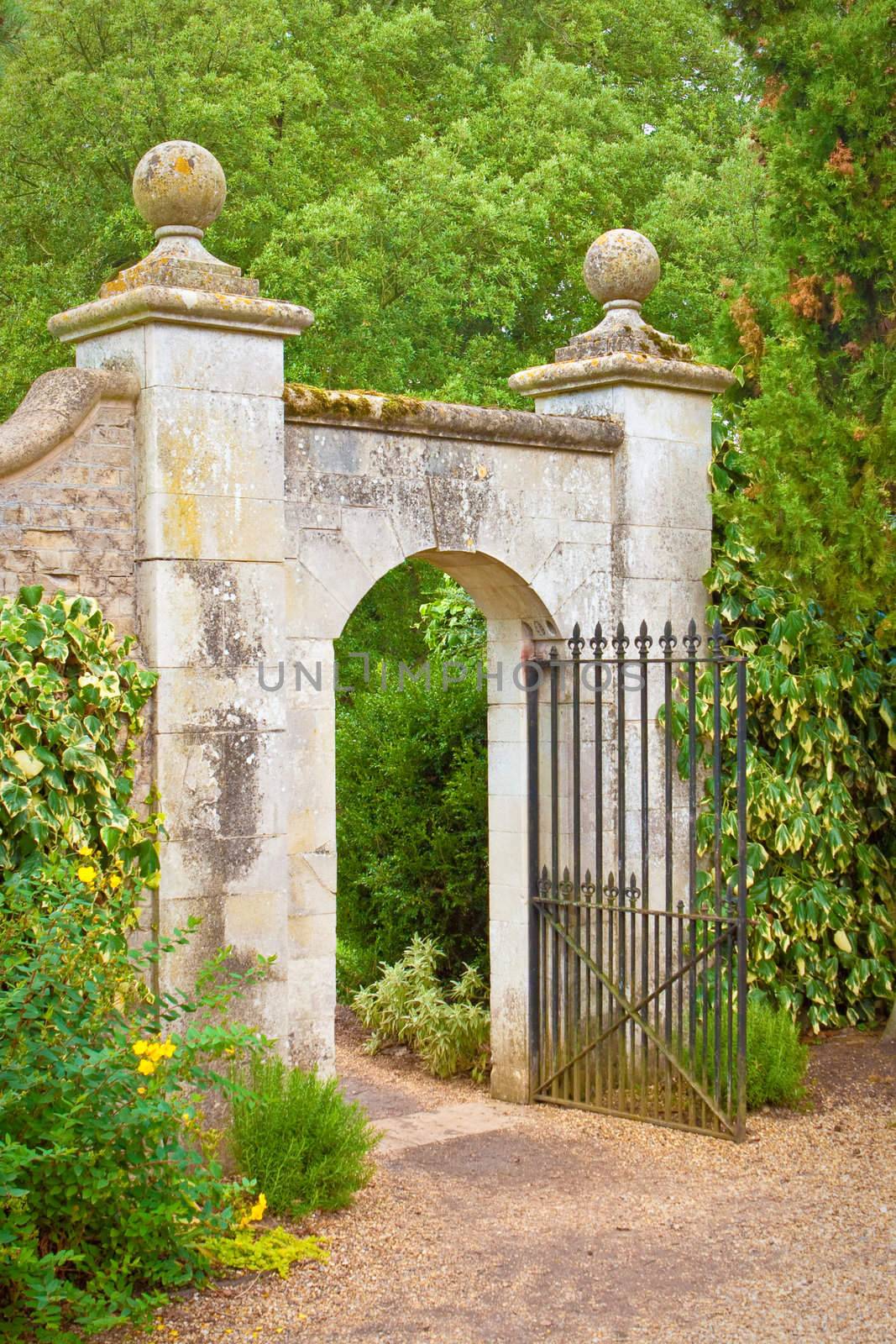 A nice gate in a stone wall in an english garden