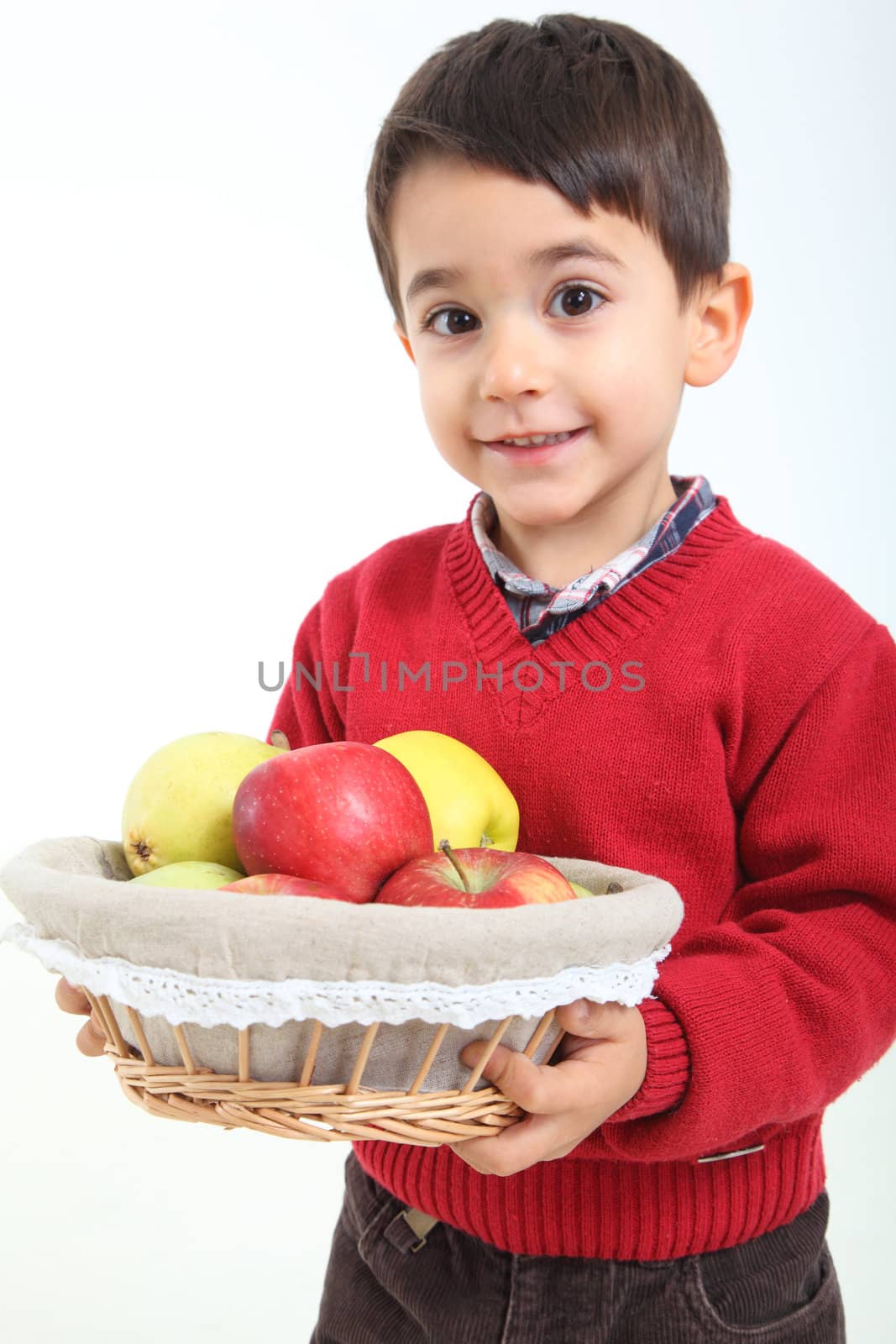 Child bringind basket fruit on white background