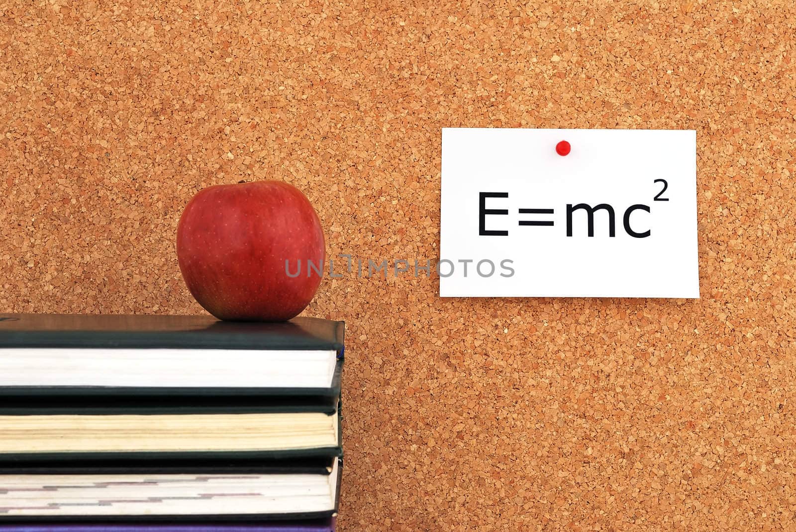 apple and books. against the background of the inscription cork board