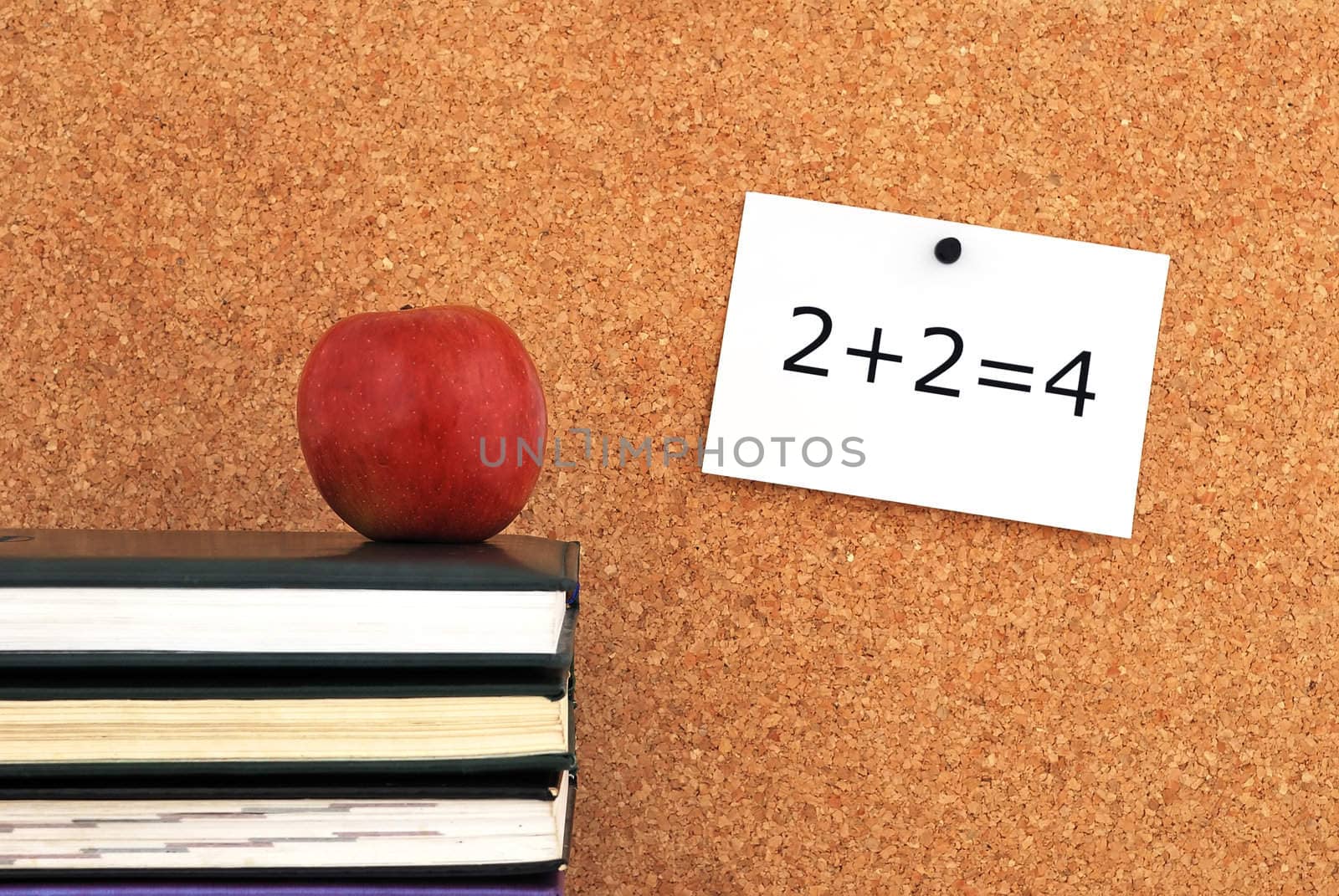 apple and books. against the background of the inscription cork board