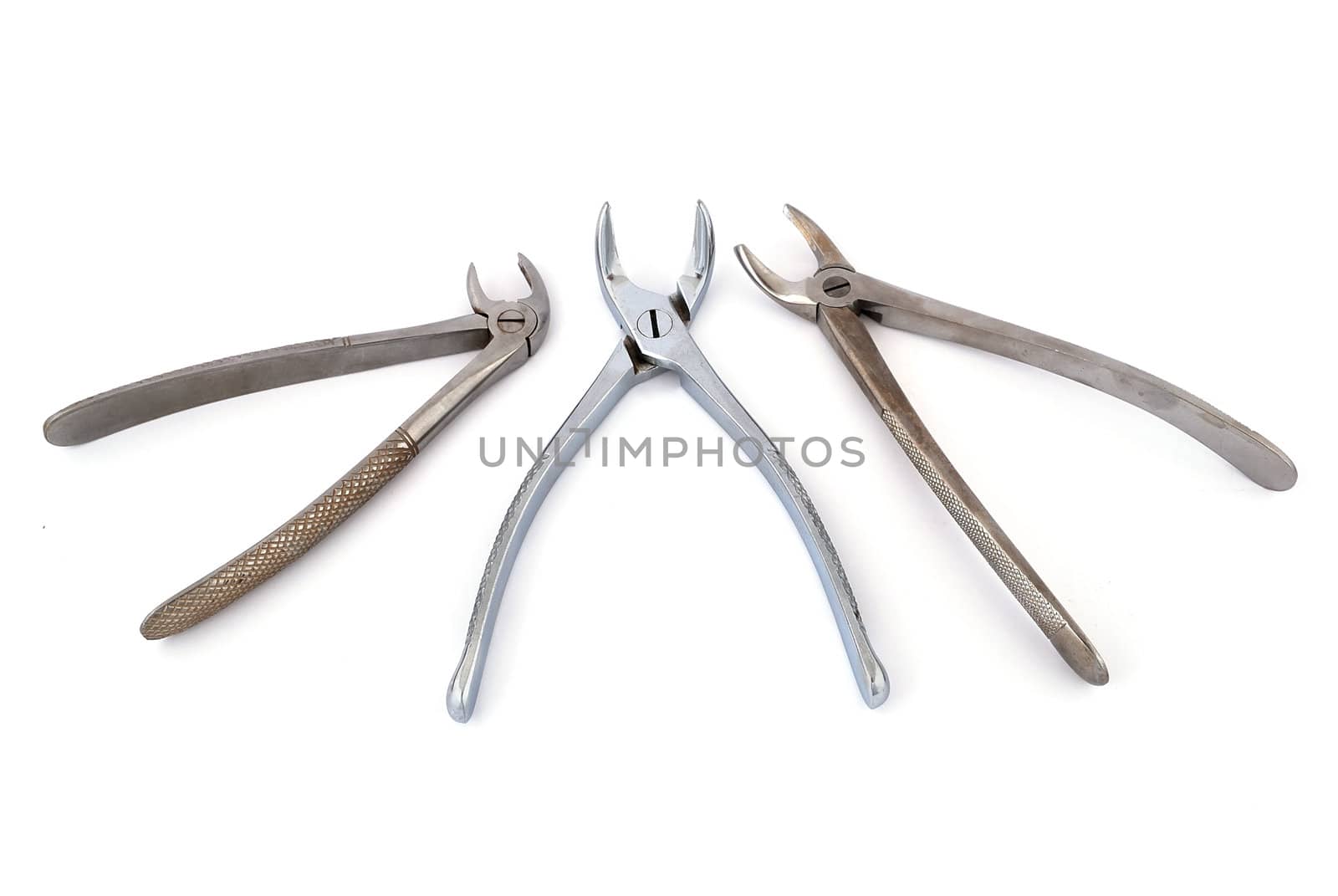 three  dental pliers on a white background